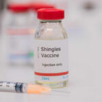 Shingles Shot Linked To Slower Aging Vial of shingles vaccine next to a syringe