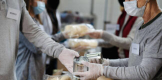 Volunteers packaging food items in a community service setting