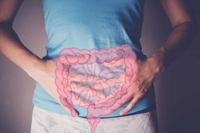 shutterstock_2154029791.jpg Person holding their stomach with a graphic of intestines overlayed