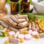 Hidden Vitamin Might Reverse Global Liver Crisis Various herbal supplements and vitamins arranged with leaves and a mortar