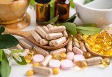 Hidden Vitamin Might Reverse Global Liver Crisis Various herbal supplements and vitamins arranged with leaves and a mortar