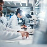 Flesh-Eating Fungus: The Hidden Blood Shield Scientists working in a laboratory with microscopes and test tubes