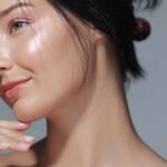 The Acne Solution Hiding in Cardiovascular Medicine Close-up portrait of a woman with glowing skin and a gentle smile