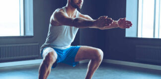 Man performing a squat exercise in a gym