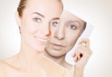 A woman holding a photo showing her younger and older self