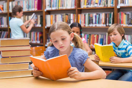 Children reading books in a library