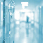 IV drip in a hospital corridor with a blurred background