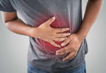 Person clutching stomach with colon illustration overlay