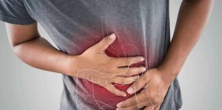 Person clutching stomach with colon illustration overlay