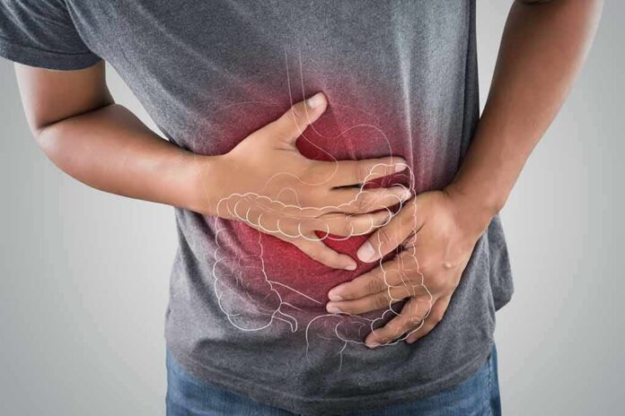 Person clutching stomach with colon illustration overlay