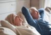 White Noise Warning Upends Sleep Health Advice Two adults relaxing on a couch with eyes closed
