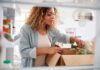 Diet Hacks That Slow Your Aging Woman unpacking groceries into a refrigerator
