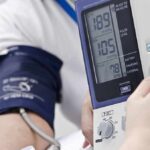 Person having blood pressure measured with digital monitor