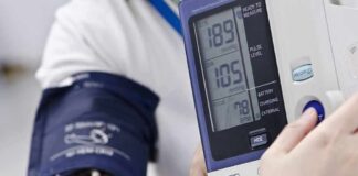 Person having blood pressure measured with digital monitor