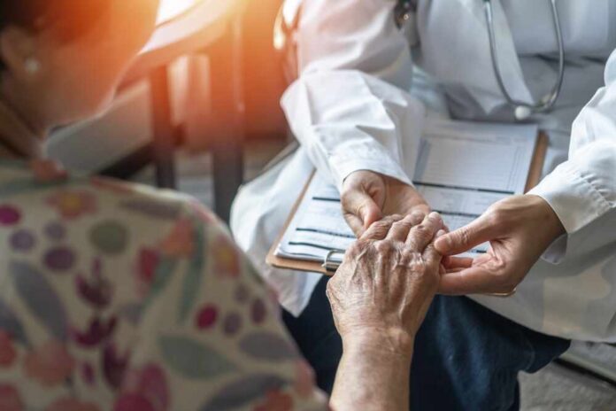 Parkinson,Disease,Patient,,Alzheimer,Elderly,Senior,,Arthritis,Person's,Hand,In A doctor holding the hand of an elderly patient during a consultation