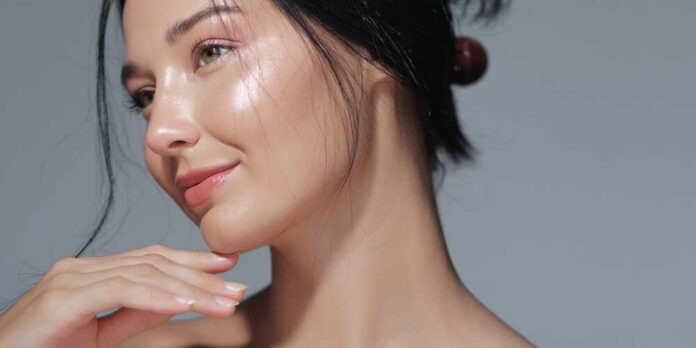 Close-up portrait of a woman with glowing skin and a gentle smile