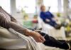 Patient arm with IV line in a hospital chair