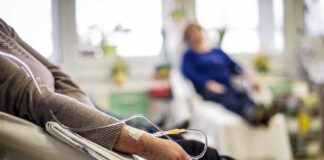 Patient arm with IV line in a hospital chair