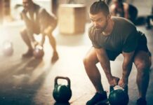 Man lifting a kettlebell in a gym