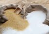 WHO Alarm: The Sweet Danger of Sugar Brown and white sugar in burlap sacks with wooden scoop