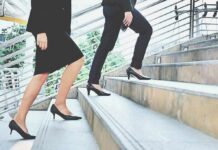 Why Climbing Stairs Is So Hard—Even When You’re In Shape Two businesspeople in formal wear walking up stairs