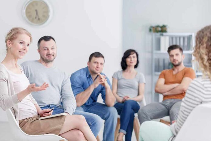 shutterstock_1056944960 Support group meeting with six adults seated in a circle