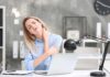 Woman at desk massaging her neck in discomfort