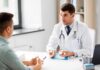 Doctor explaining glucose meter to patient during consultation