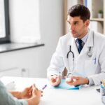 Diabetes Rule Flip: Clock Beats Calories Doctor explaining glucose meter to patient during consultation