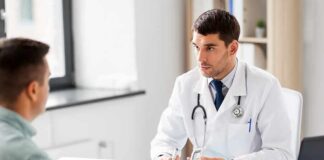 Doctor explaining glucose meter to patient during consultation