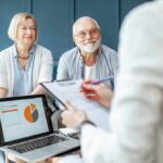 Healthy Aging: Evidence Based Habits for Lifelong Vitality senior couple meeting with advisor at home