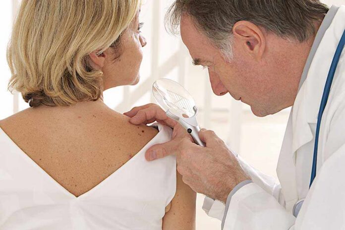 Doctor,And,Patient,-,-,Looking,For,Skin,Disease Doctor examining a patients skin with a magnifying glass