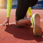 The Anxiety Spiral That Drains Legs Before Race Day sprinter at starting blocks on track