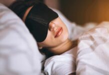 The Surprising Danger of Back Sleeping Woman sleeping with a black eye mask in bed