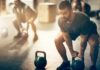 Gym Hustle Culture’s Hidden Health Toll Man lifting kettlebell in gym