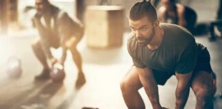 Man lifting kettlebell in gym