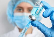 Drill-Free Cavity Killer Stuns Dentists Healthcare worker drawing blue liquid from vial with syringe