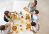 This Popular Eating Habit Was Linked To Crohn’s Disease Group of friends eating lunch at a cafeteria table