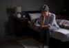 How Poor Sleep Affects Your Inflammation Levels Older adult sitting on bed with head in hand