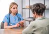 Healthcare professional consulting with an older woman at a desk