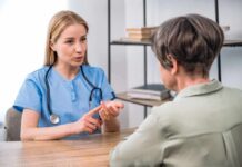 Warning Signs of Iron Deficiency Healthcare professional consulting with an older woman at a desk
